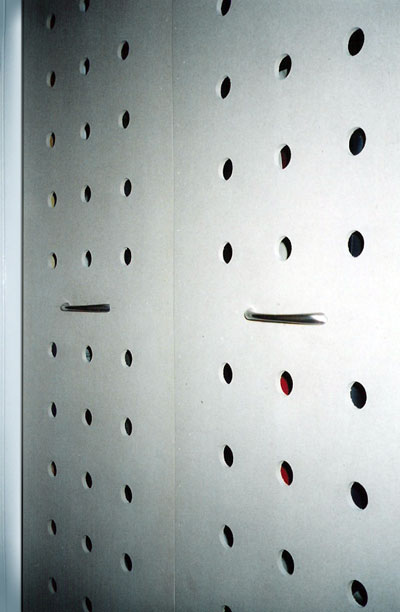 Close up view of drilled gatefold closet doors