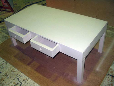 Top view of a white coffee table with both drawers open