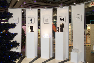 White plinths of various sizes with decorative items on them