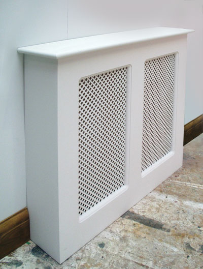 Three-quarter view of a wooden radiator cover with two mesh panels, finished in gloss white