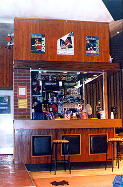 view of stage set - wood and brick bar with bar-stools, beer pumps and optics behind the counter