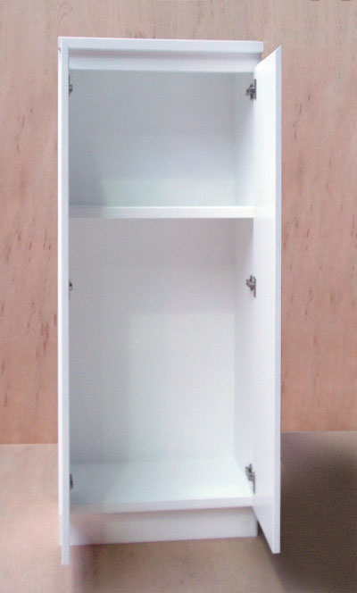 Front view of a white cabinet with the doors open showing a shelf about three-quarters of the way up the interior