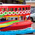 Close-up detail of a parade float in the form of a red boat
