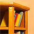 Close-up detail of a scale model of a bookcase with books