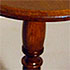 Close-up detail of the base of a round wooden table